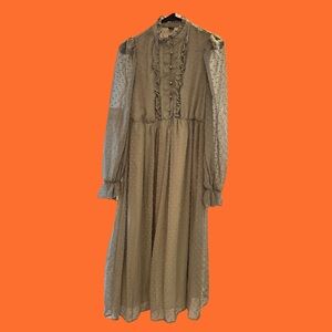 Sage green maxi dress with sheer polka dot sleeves and ruffle collar.